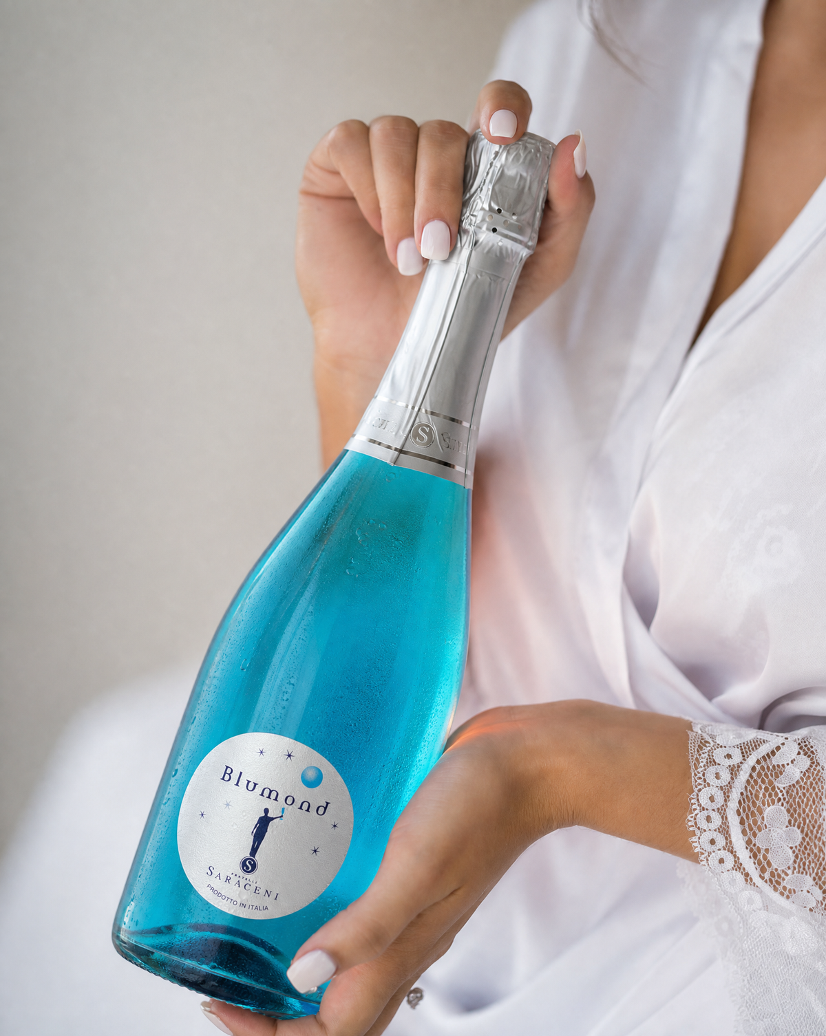 Blumond Blue Bubbly — bright blue Italian sparkling sweet wine, 750ml, Saraceni Wines (wedding lifestyle shot)